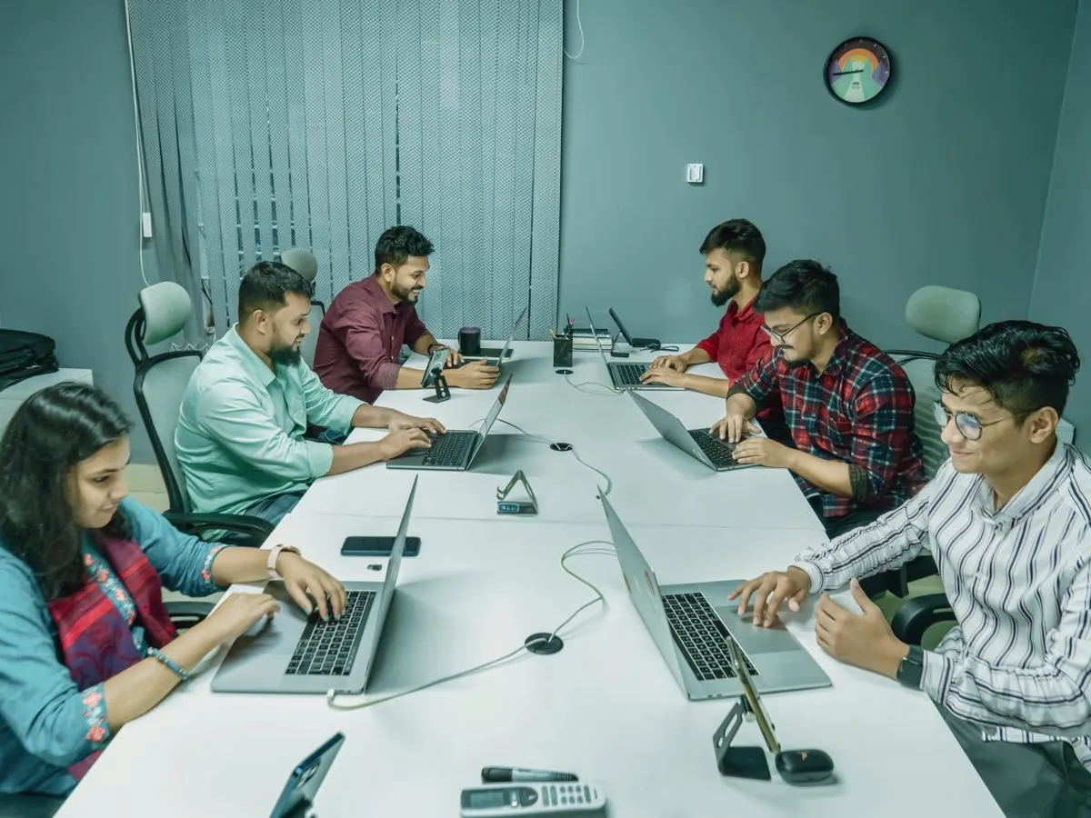Professionals working on laptops in an office