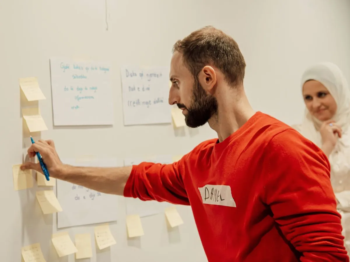 Colleagues arranging sticky notes during a workshop