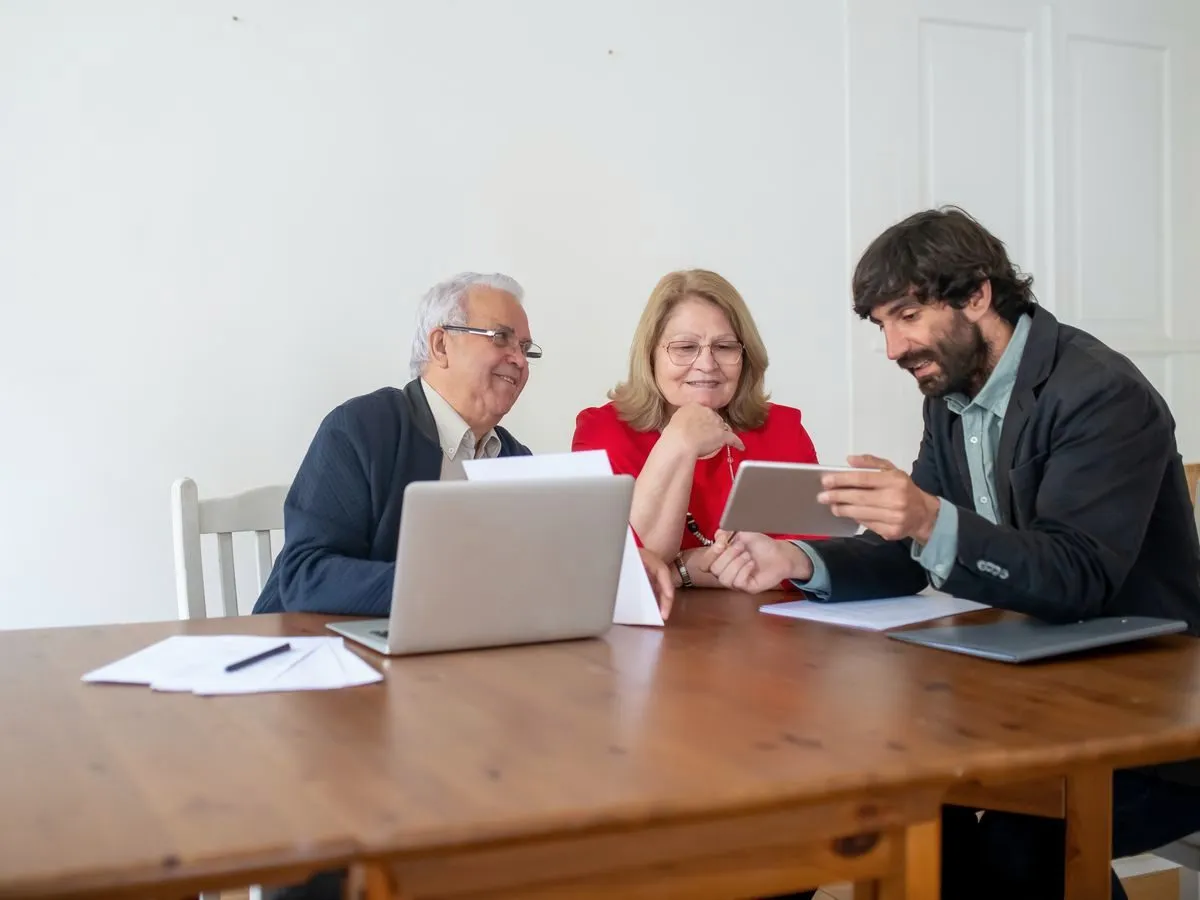 Consultant with clients reviewing documents