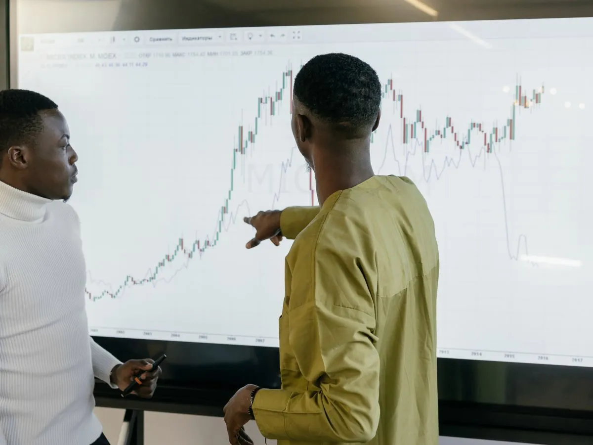 Two professionals discussing trends on a chart
