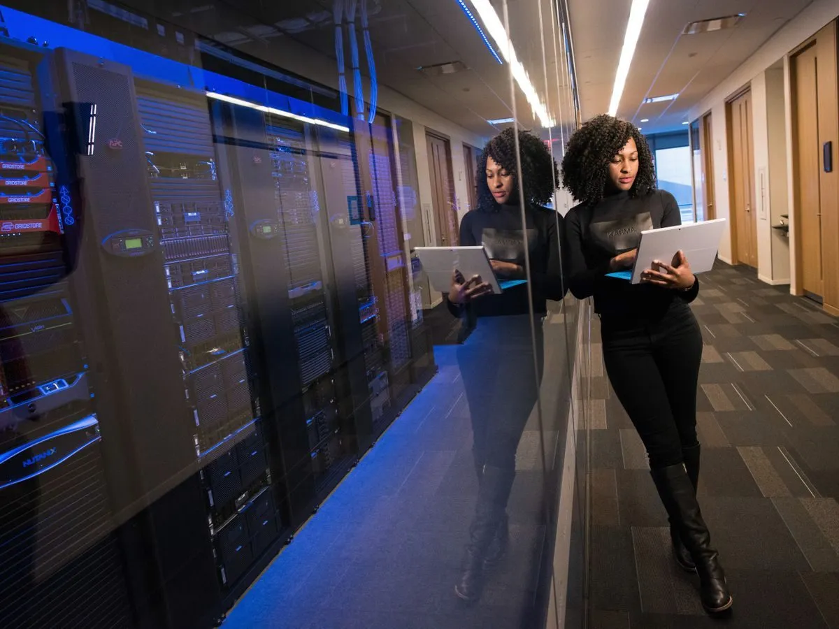 Engineer walking through a data centre with a laptop
