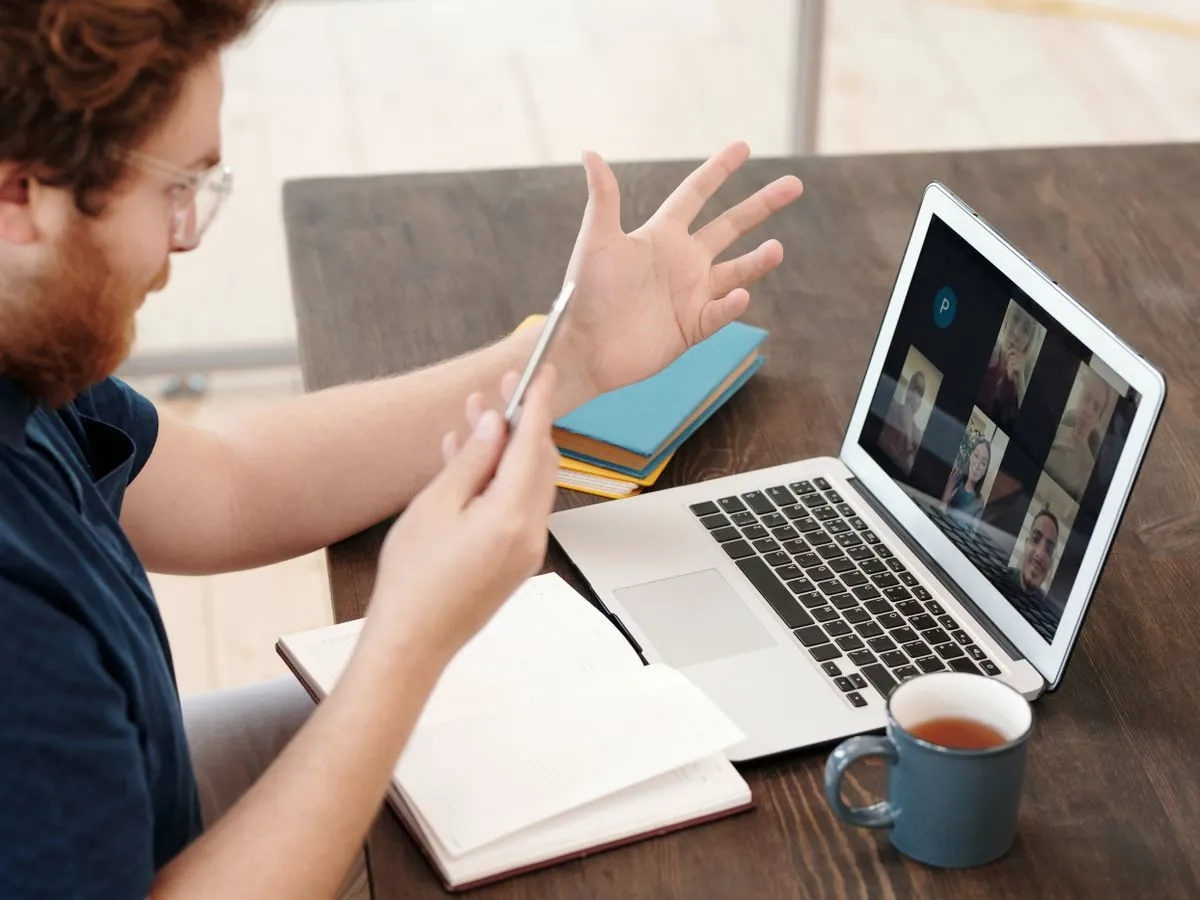 Man attending an online session on a laptop