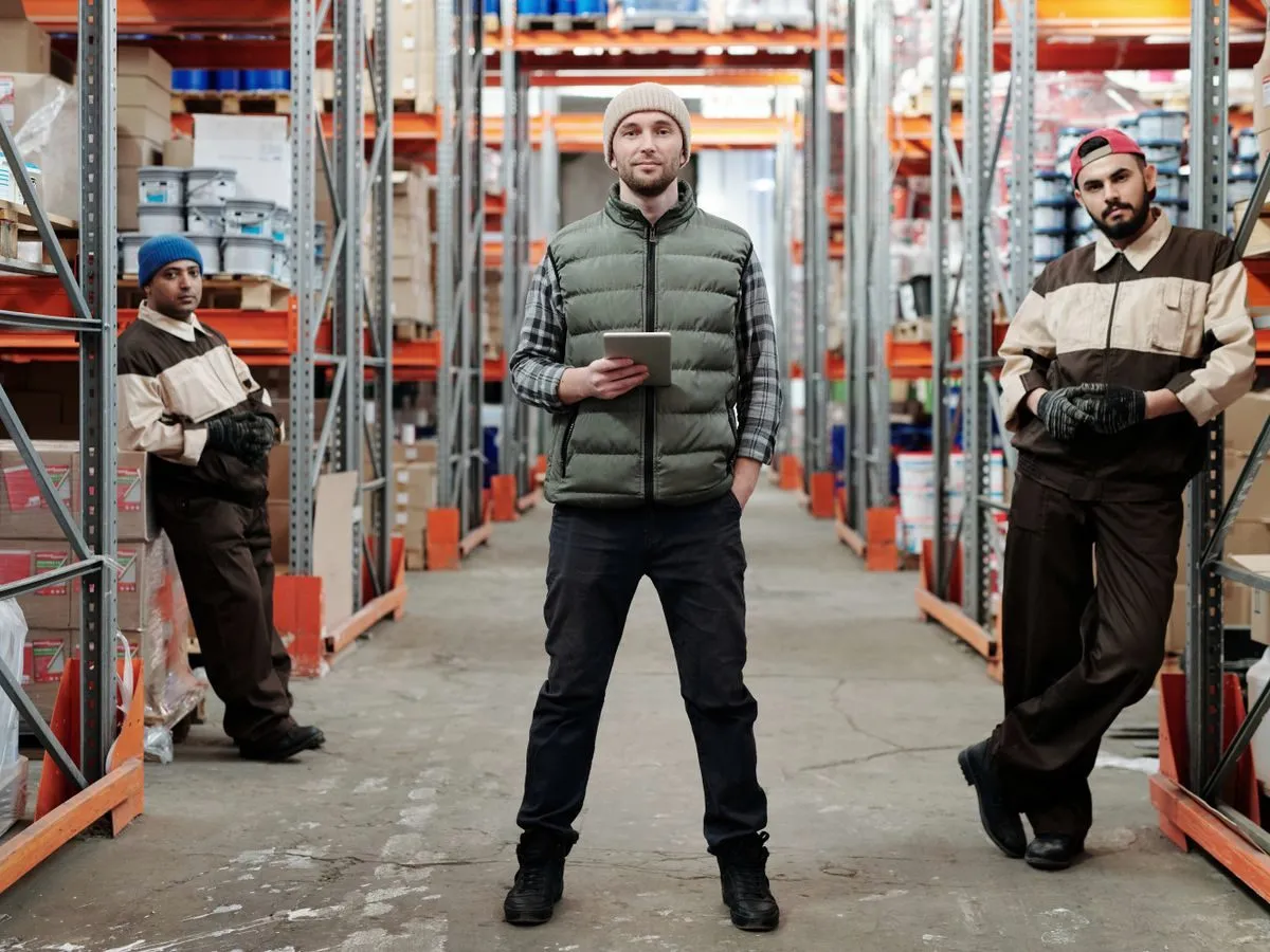 Warehouse team among stocked shelves