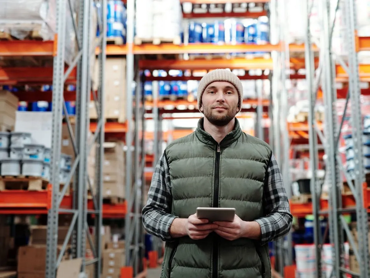 A warehouse manager checking stock on a tablet
